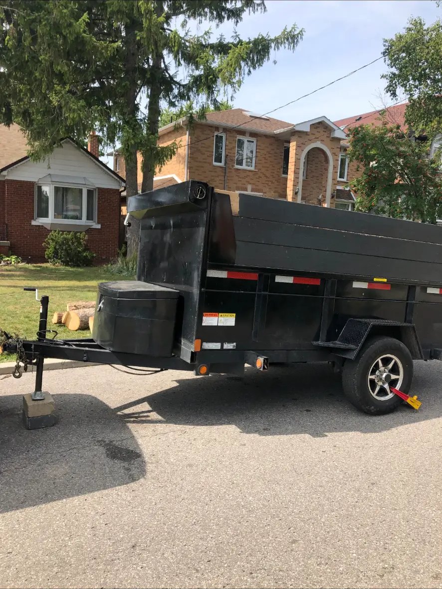 V Rentals 5x10 single-axle dump trailer parked on a residential street in the GTA